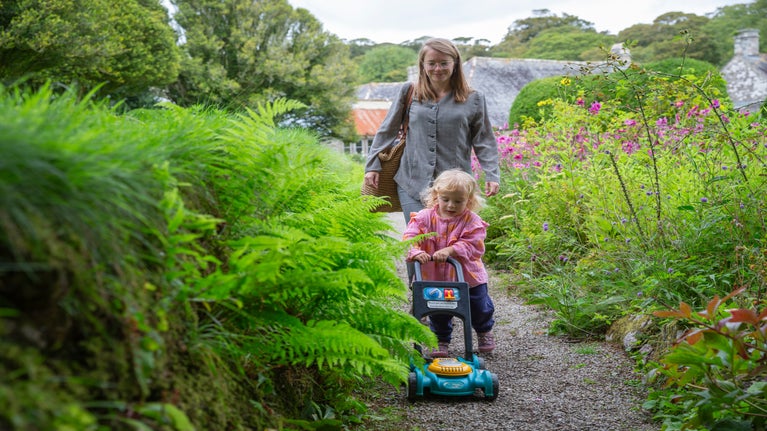 A family walking in the gardens at Godolphin, Cornwall
